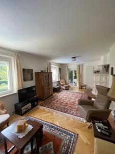 a living room with a couch and a table at Ferienhaus Casa Maria in Klagenfurt am Wörthersee in Waltendorf +14 photos
