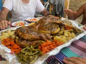 a tray of meat and vegetables on a table at La Belle Etoile in Ouazzane