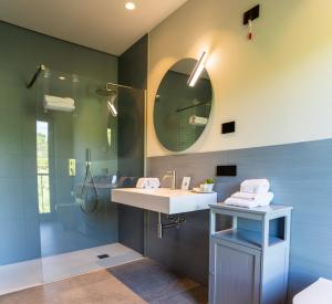 a bathroom with a sink and a mirror at Agriturismo Demarie in Vezza d'Alba +25 photos