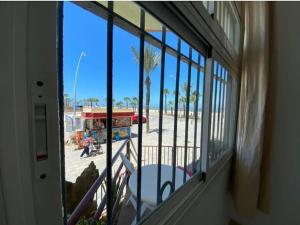 a window of a store with a view of a street at Apartamento Infantes Playa in Sanlúcar de Barrameda