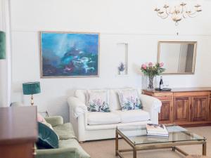 a living room with a couch and a table at Mouille Point Villa Capri in Cape Town