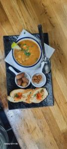 a plate of food with soup and bread on a table at Dar Hbabi in Agadir +3 photos