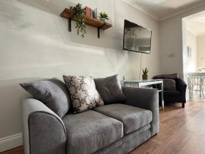 a living room with a couch and a table at Durham 3 Bedroom House With Parking in Durham