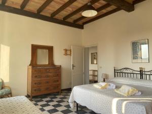 a bedroom with two beds and a dresser and a mirror at CasaLeTolfe Residence in Siena +133 photos