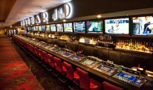 a bar with red chairs in a casino at The D Las Vegas in Las Vegas