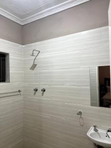 ein Badezimmer mit Dusche und Waschbecken in der Unterkunft Lulu Guest Lodge, Low-Density Suburbs, Victoria Falls in Victoriafälle