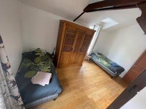 an attic room with a bed and a window at 200 M2 Dreamhouse for 10 with private pool and garden in beautiful park in Montévrain