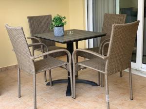 a table and chairs with a potted plant on it at Adeste to Ioannina Apartment in Ioannina +3 photos