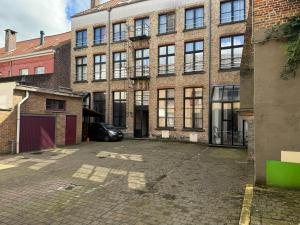 an empty parking lot in front of a brick building at Zakske13 - Design Boutique B&B in Bruges city centre in Bruges