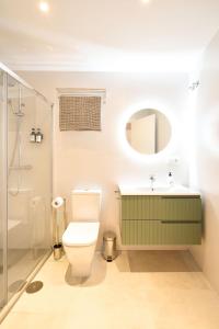 a bathroom with a toilet and a sink and a shower at La brisa del Jerte by keyhom in Plasencia