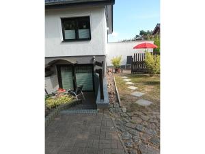 a house with a brick walkway leading into a yard at Ferienwohnung Krentz in Neu Sallenthin