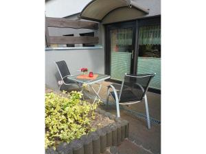 a table and chairs sitting on a patio at Ferienwohnung Krentz in Neu Sallenthin