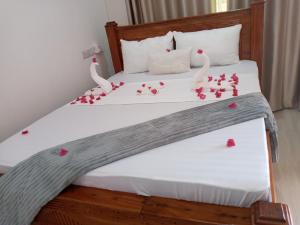 a bedroom with a bed with hearts on it at Jawda in Nungwi +31 photos