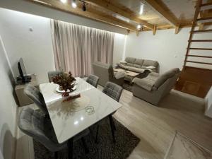 a living room with a table and a couch at Vila Malineta in Žabljak