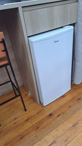 a white refrigerator in a kitchen next to a counter at Cabana Bolha Urubici in Urubici