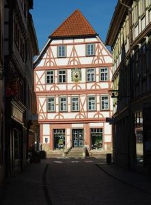 a large building with a clock on it in a street at Lutherwohnung Schmalkalden in Schmalkalden