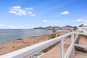 a view of the beach from the balcony of a beach house at Canteras 1º Linea de Playa in Las Palmas de Gran Canaria