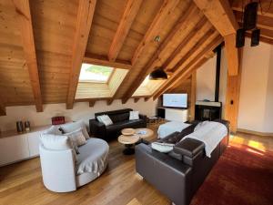 a living room with a couch and a table at Chalet Red Mount - Esprit chalet au pied des pistes in Les Deux Alpes