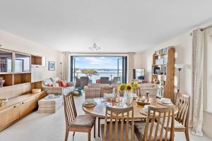 a living room with a table and chairs at B6 Masts - With sea views, parking and terrace in Torquay