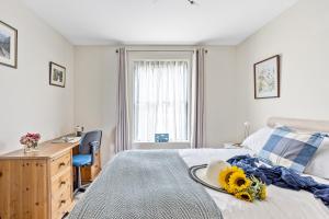 a bedroom with a bed with sunflowers on it at B6 Masts - With sea views, parking and terrace in Torquay