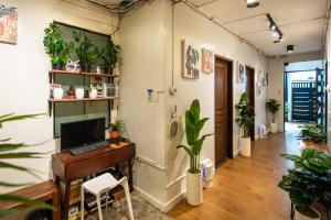 an office with a desk with a computer and plants at Homey and Cozey Poblacion Makati S02 in Manila