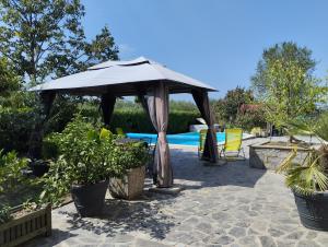 a patio with an umbrella and a swimming pool at Apartment Rose in Koper