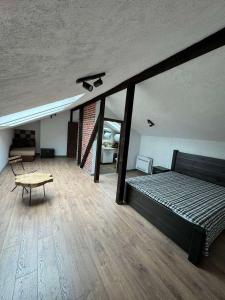 a bedroom with a bed and a table in a room at Къща за гости ДворЪ in Skandaloto +9 photos