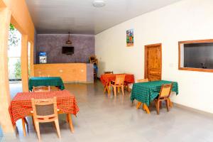 a restaurant with tables and chairs with green tablecloths at BEZINDA LODGE in Dodoma