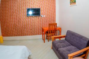 a living room with a couch and a table at BEZINDA LODGE in Dodoma