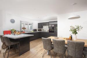 a kitchen and dining room with a table and chairs at Tre Lowen, Goonhavern, Perranporth - Free Parking - Free Wifi - Games Room in Perranporth