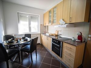 a small kitchen with a table and a table and chairs at Apartman Casa di Tasa in Veliko Gradište