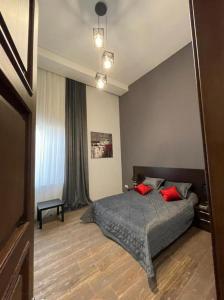 a bedroom with a bed with two red pillows at Merdekan Villa in Mardakan