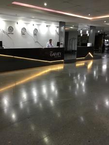 a man standing at a counter in an airport at Exelente Apart hotel otima localizaçao in Brasilia +27 photos