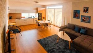 a living room with a couch and a table at Three Diamonds Residence in Dunajská Streda