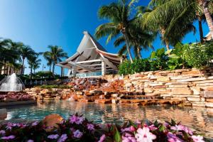 a resort with a swimming pool and palm trees at JW Marriott Marco Island Beach Resort in Marco Island