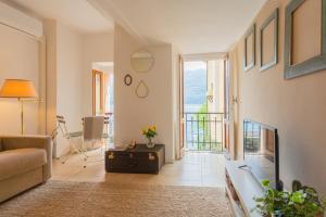 a living room with a couch and a table at Il Porticciolo by Rent All Como in Carate Urio