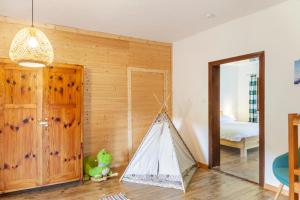 a room with a bed and a tent in it at Kärntner Bauernhaus in Panoramalage in Laas