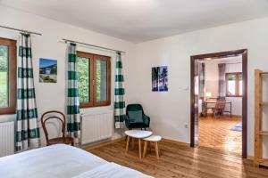 a bedroom with a bed and a table and a chair at Kärntner Bauernhaus in Panoramalage in Laas +29 photos