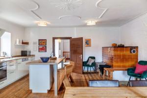 a kitchen and living room with a table and chairs at Kärntner Bauernhaus in Panoramalage in Laas