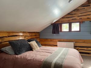 a bedroom with a bed in a room with wooden walls at Oceana Suites Hotel Volkano in Malalcahuello