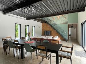 a dining room with a table and chairs and a couch at La Villa Atea in Joue-les-Tours