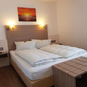 Postel nebo postele na pokoji v ubytování Hotel Mühleneck