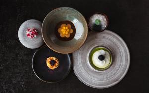 a group of bowls with food in them on a table at Auberge Saint-Mathieu in Saint Mathieu Du Parc
