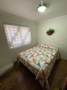 a bedroom with a bed in a room with a window at Casa en El Canelo - Algarrobo in Algarrobo