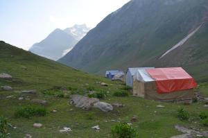 a group of tents on a hill with mountains in the background at Outdoor Adventures Camp Ratti Gali Lake in Shardi +10 photos