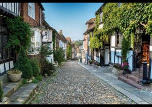 a cobblestone street in an old town with buildings at The Waves - Camber Sands - East Sussex in Camber