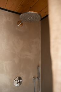a bathroom with a shower with a light on the ceiling at Gastenverblijf Begheynhof in Biervliet +21 photos