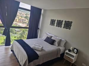 Postel nebo postele na pokoji v ubytování Cielito Lindo, vista espectacular en 11 nivel + 17 fotografií