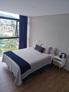 Postel nebo postele na pokoji v ubytování Cielito Lindo, vista espectacular en 11 nivel