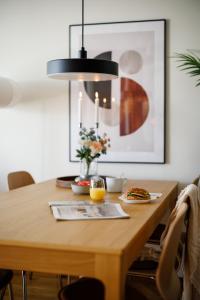a dining room table with a black pendant light at Guestly Homes - 3BR Superior Apartment in Boden
